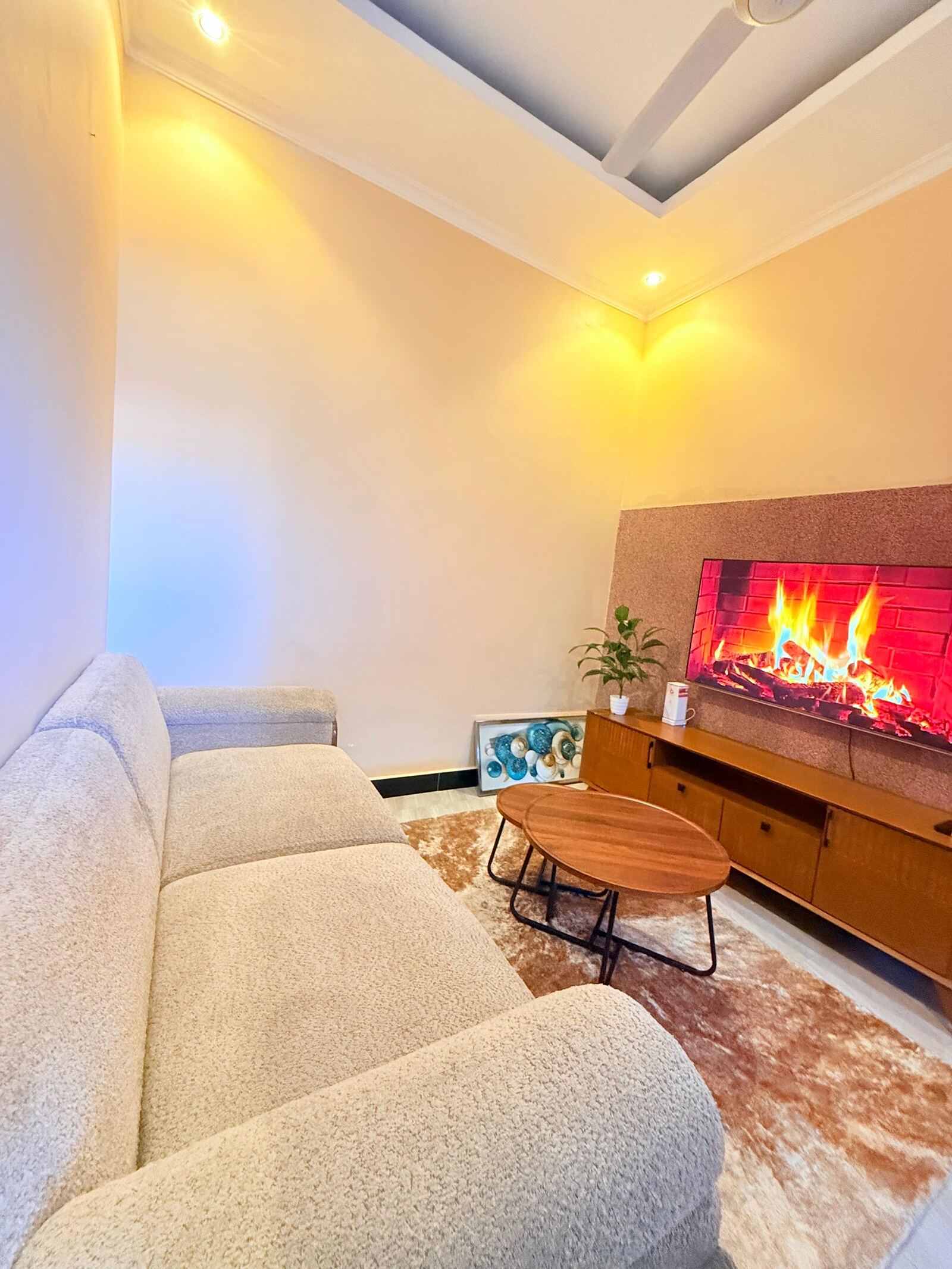 Sinza living room with cream sofa and smart TV